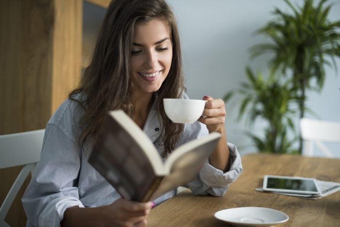 Woman reading Korean books and drinking coffee