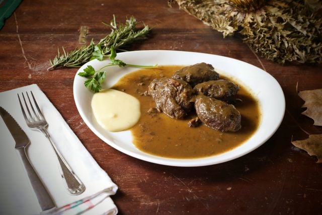Pašticada, a traditional Dalmatian slow-cooked beef dish, served with sauce and mashed potatoes.